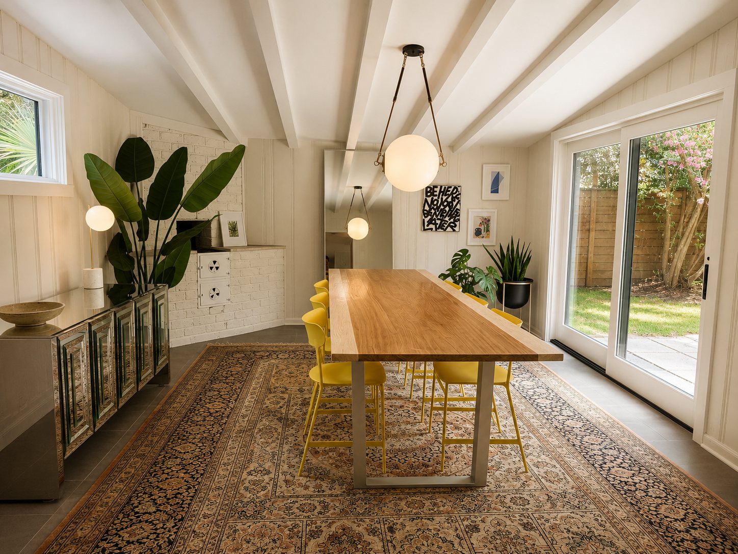 Dining room with vaulted beamed ceiling and sliding glass doors to the backyard