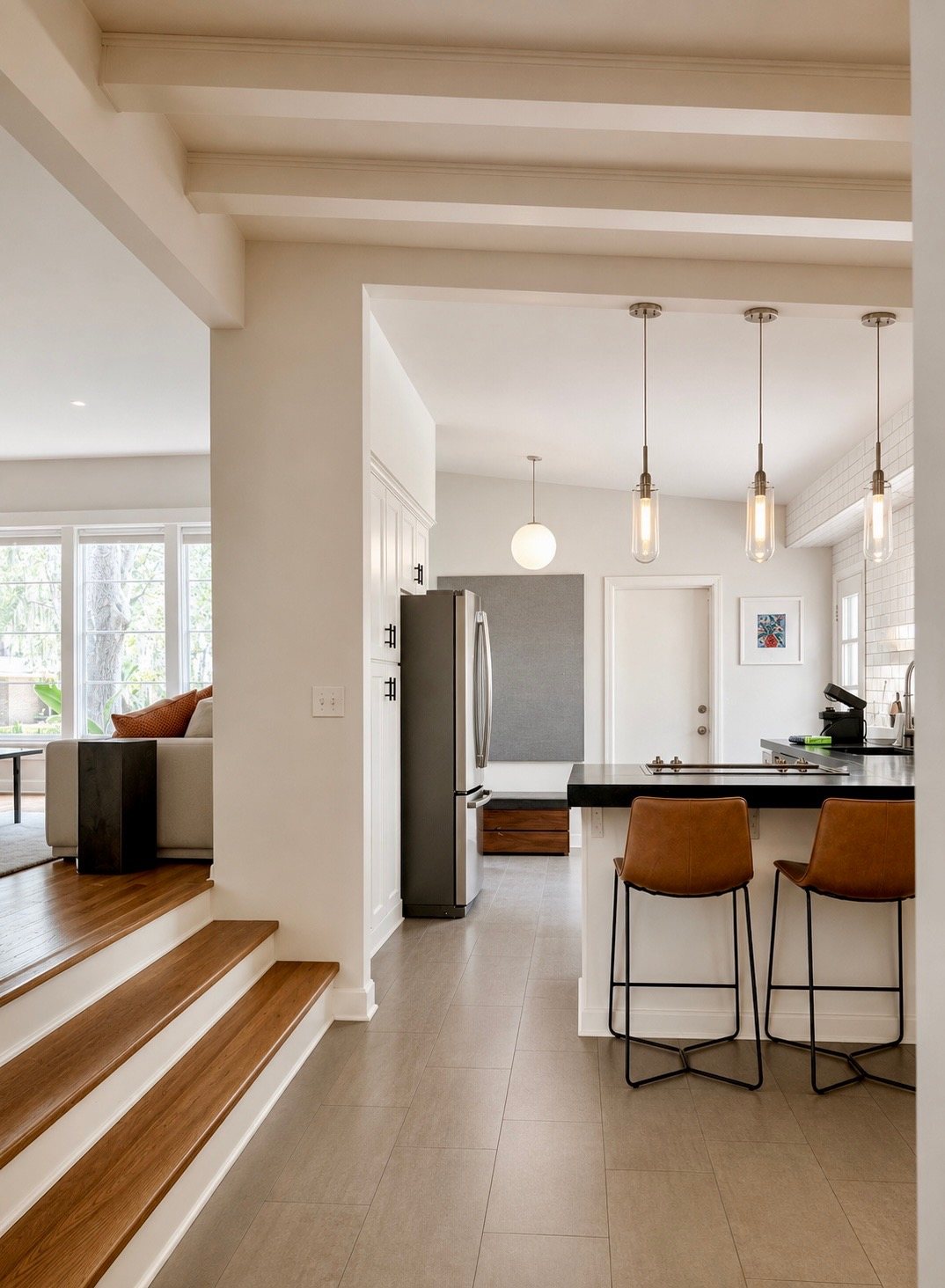 Kitchen and breakfast bar seen from the sunken living room steps